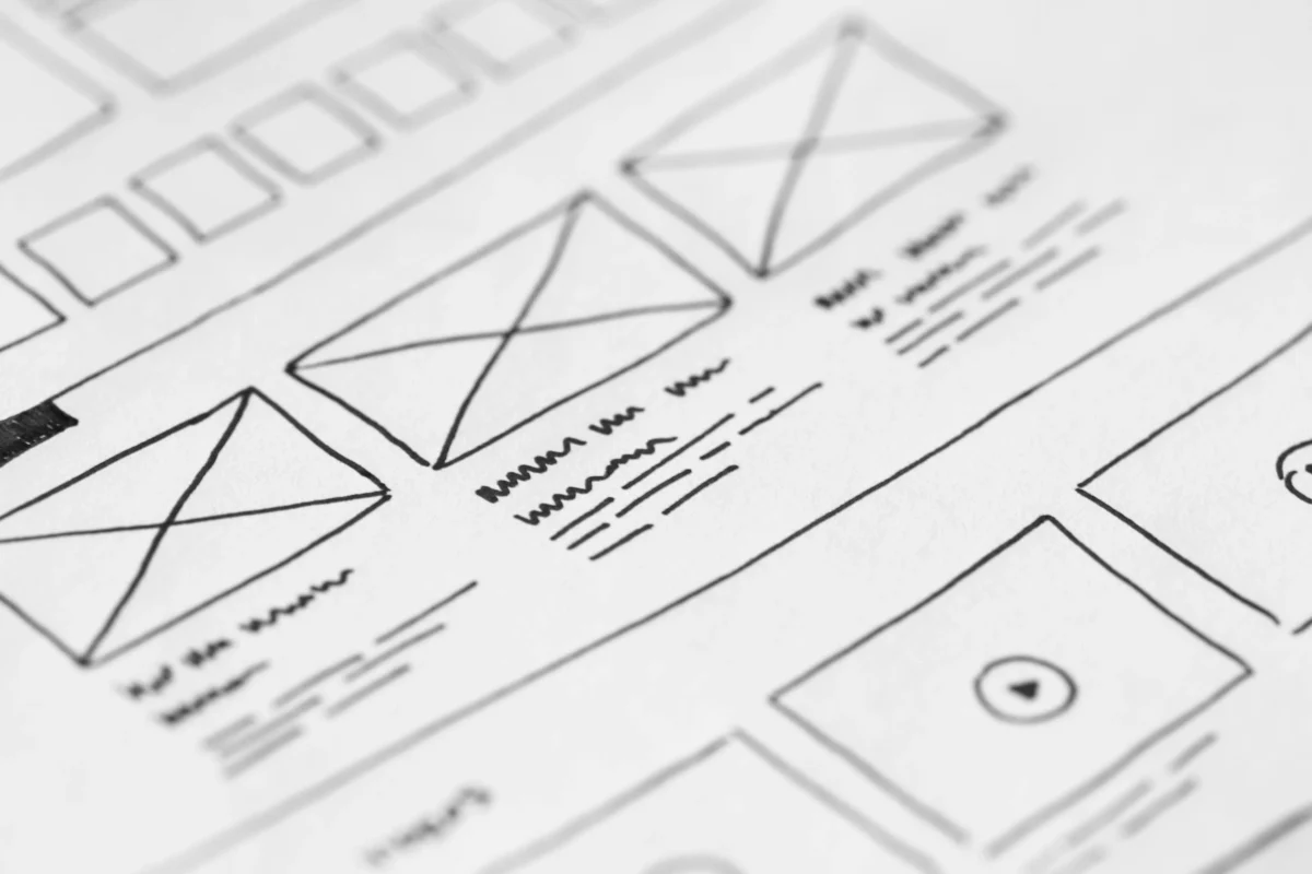 Detailed close-up of a hand-drawn wireframe design on paper for a UX project.